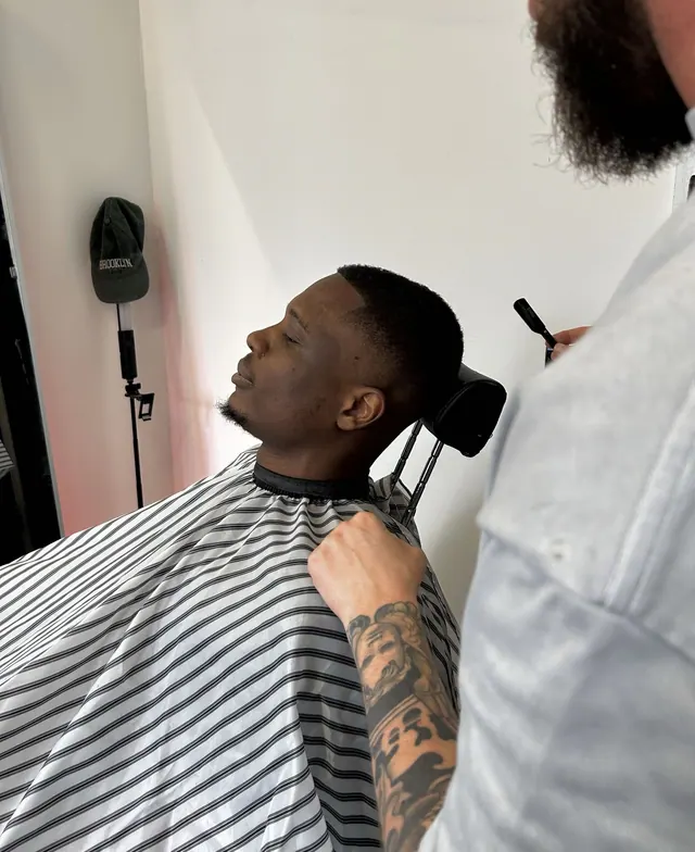 A client in the chair mid-cut